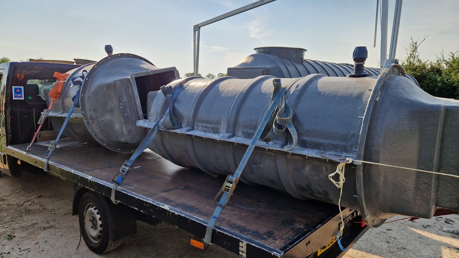FORS Gold flatbed truck transporting industrial tanks — dedicated haulage by 24/7 Deliveries Ltd