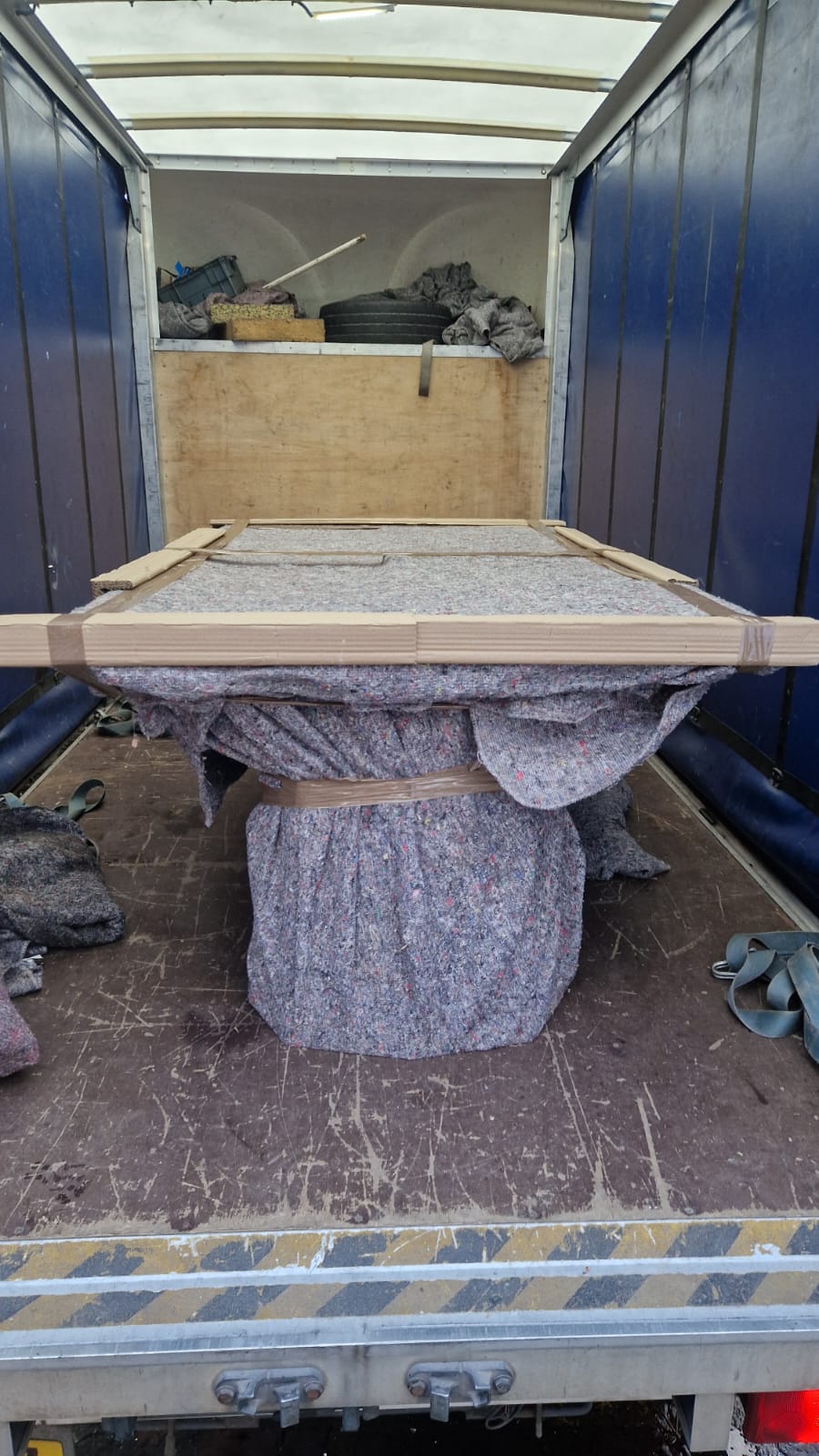 Specialist fragile item wrapped and blanket-protected for dedicated courier delivery
