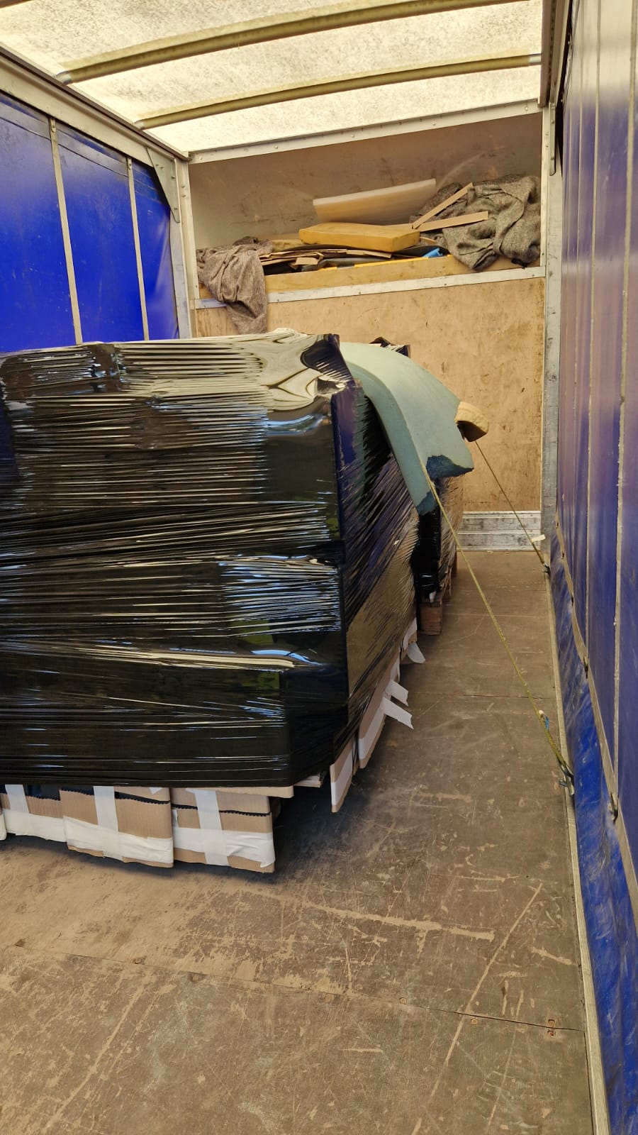 Wrapped pallet load secured inside a curtainsider — same day dedicated delivery